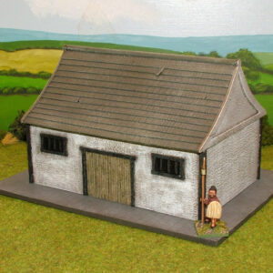 Single story warehouse with slate roof and barred windows.